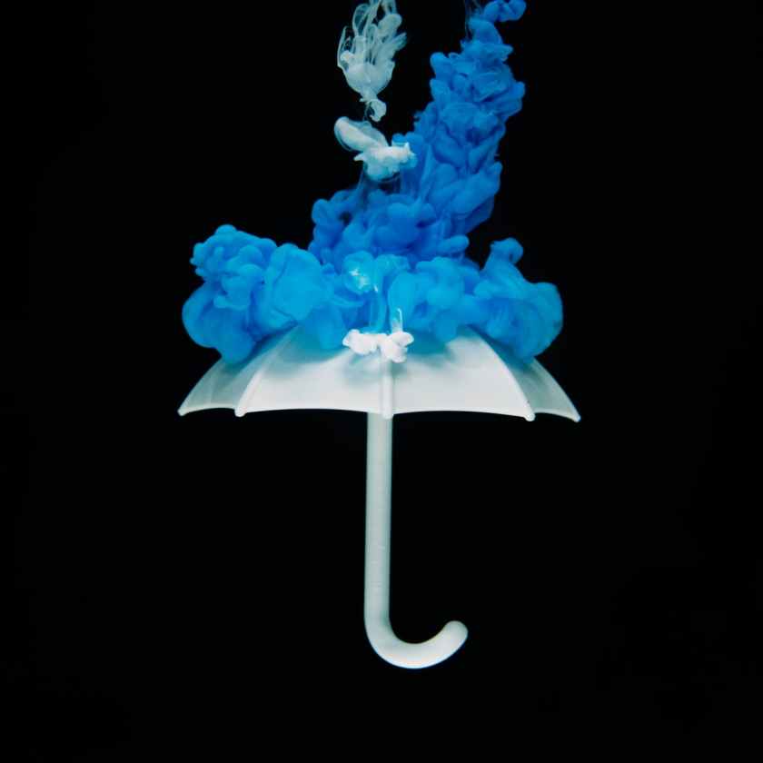 photo of white umbrella with blue smoke illustration